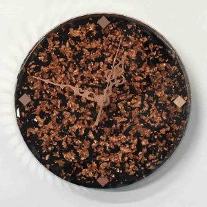 Clock with rose gold metal leaf