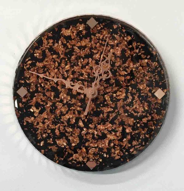Clock with rose gold metal leaf